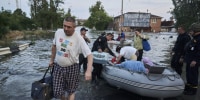 Thousands evacuate Kherson after major dam destroyed