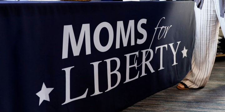 A woman organizes Moms for Liberty apparel at the inaugural Moms For Liberty Summit